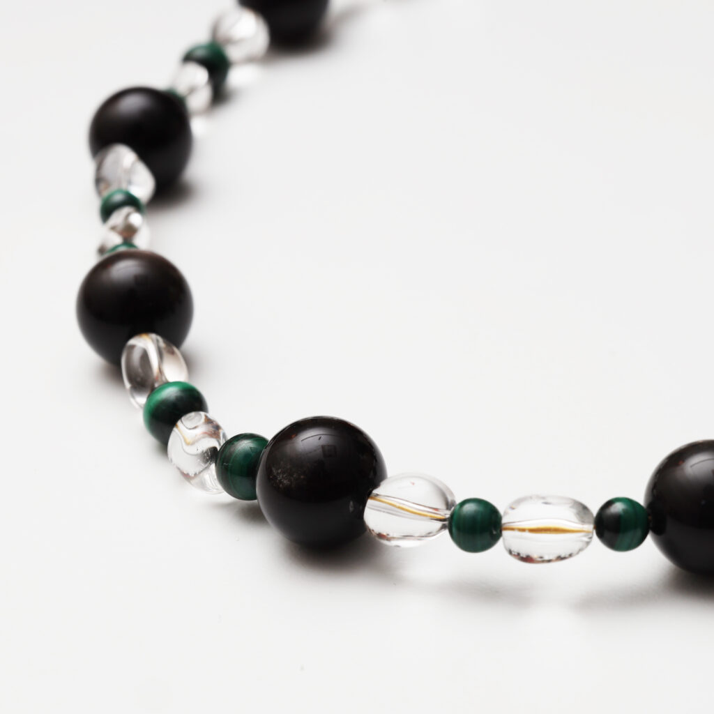 A model wearing the Moon Whisper necklace in soft light