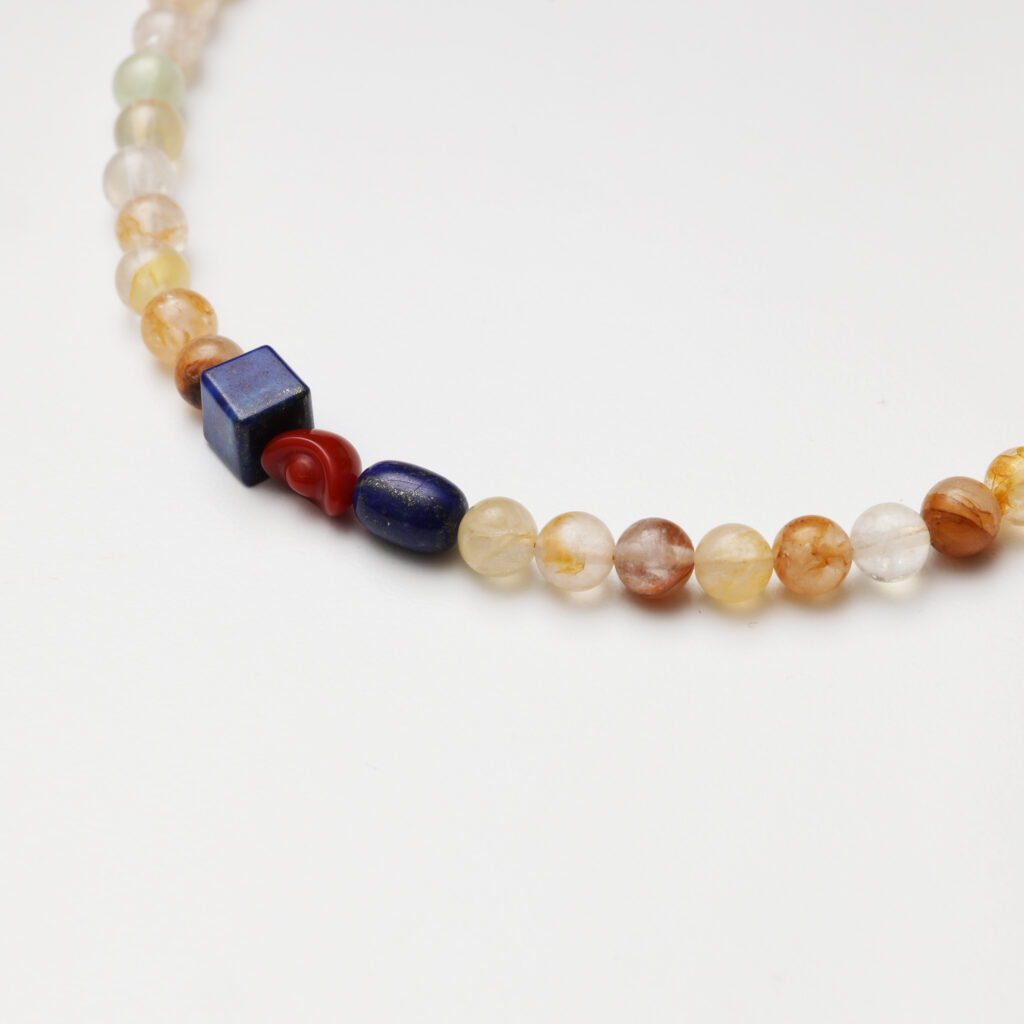 A model wearing the Moon Whisper necklace in soft light