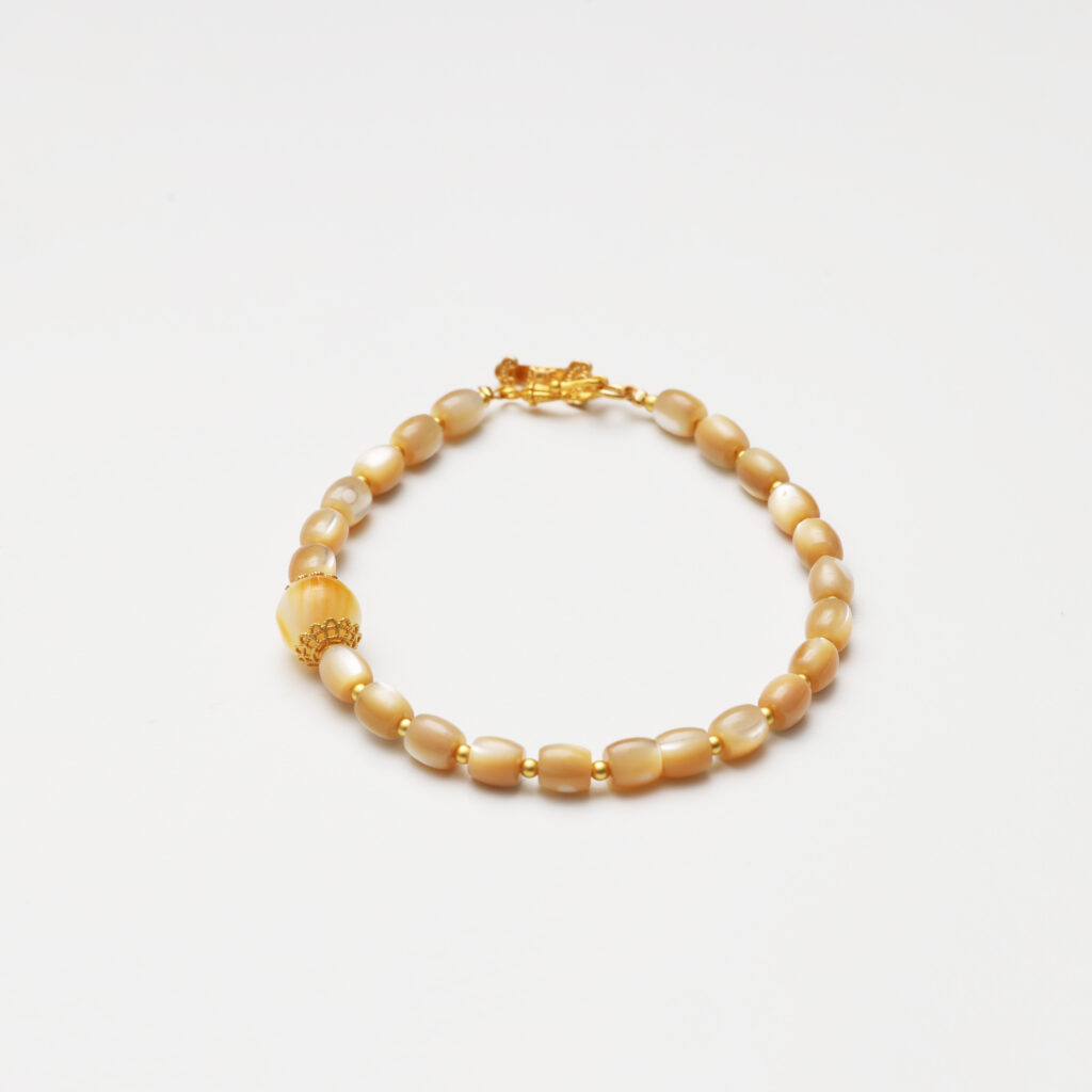 A model wearing the Moon Whisper necklace in soft light