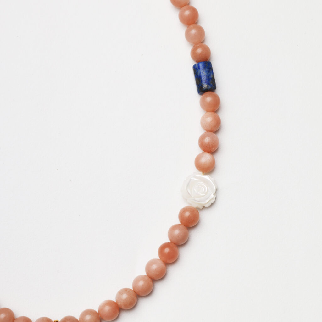 A model wearing the Moon Whisper necklace in soft light