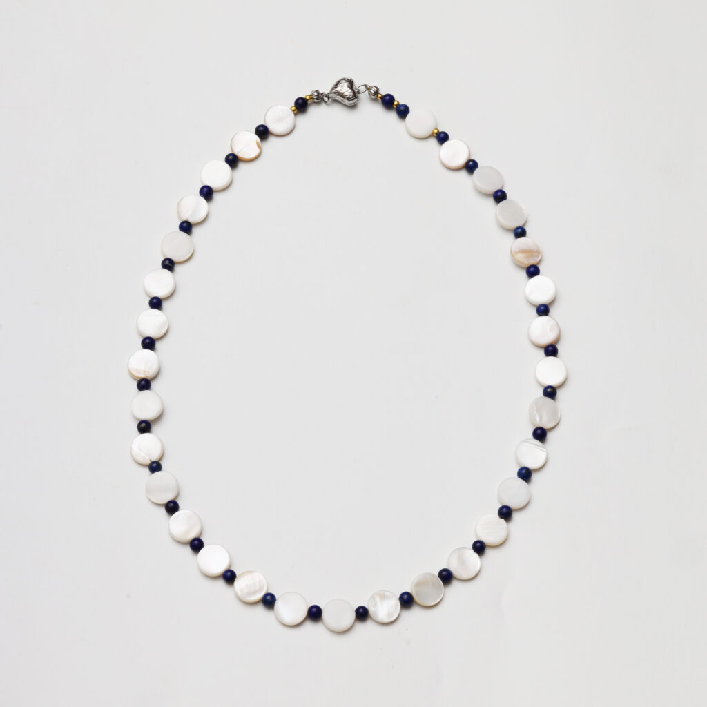 A model wearing the Moon Whisper necklace in soft light