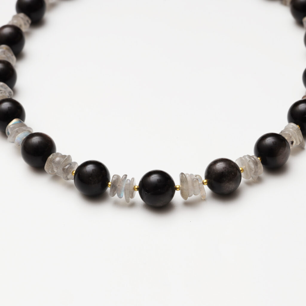 A model wearing the Moon Whisper necklace in soft light