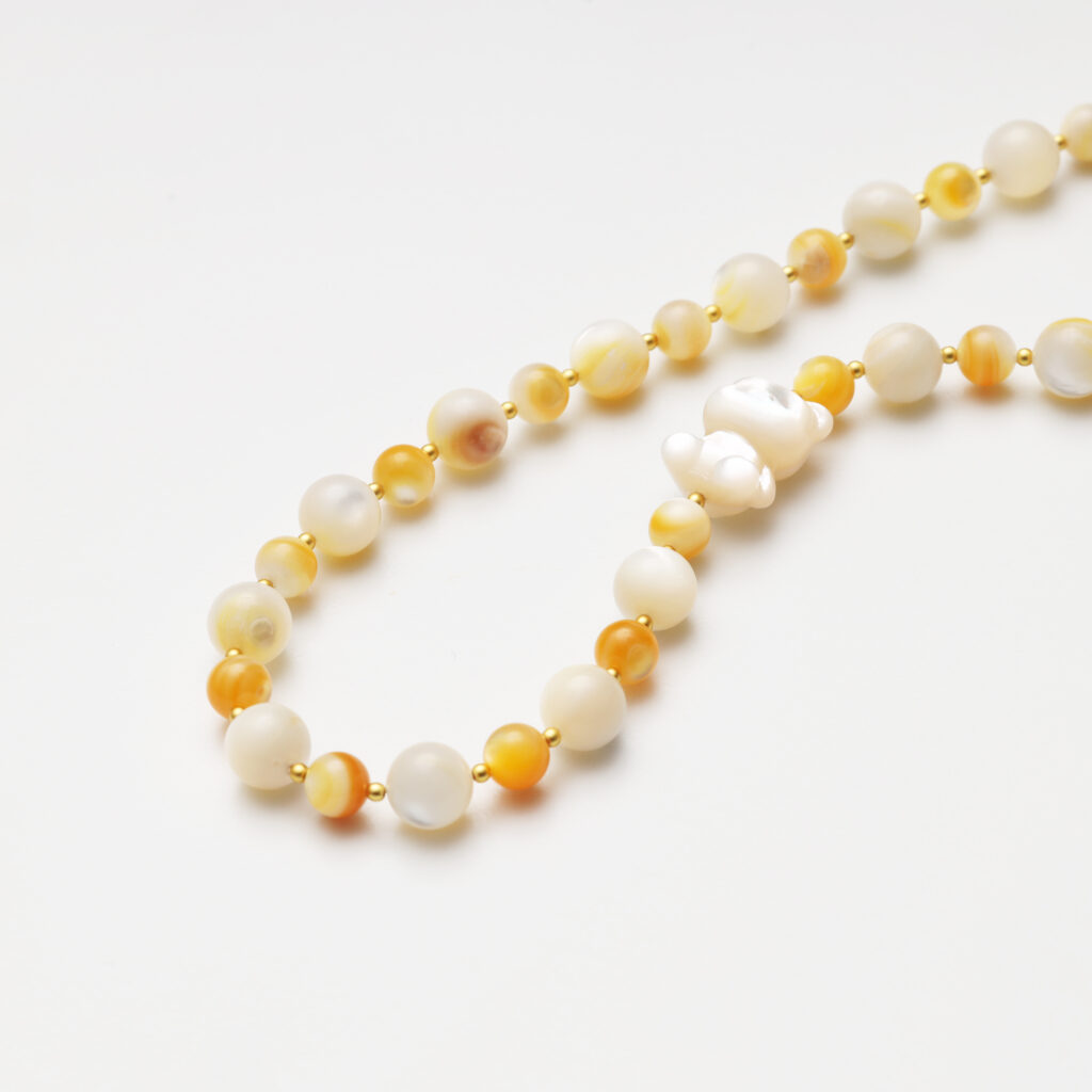 A model wearing the Moon Whisper necklace in soft light