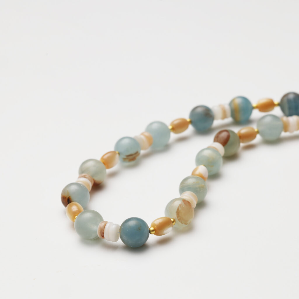 A model wearing the Moon Whisper necklace in soft light