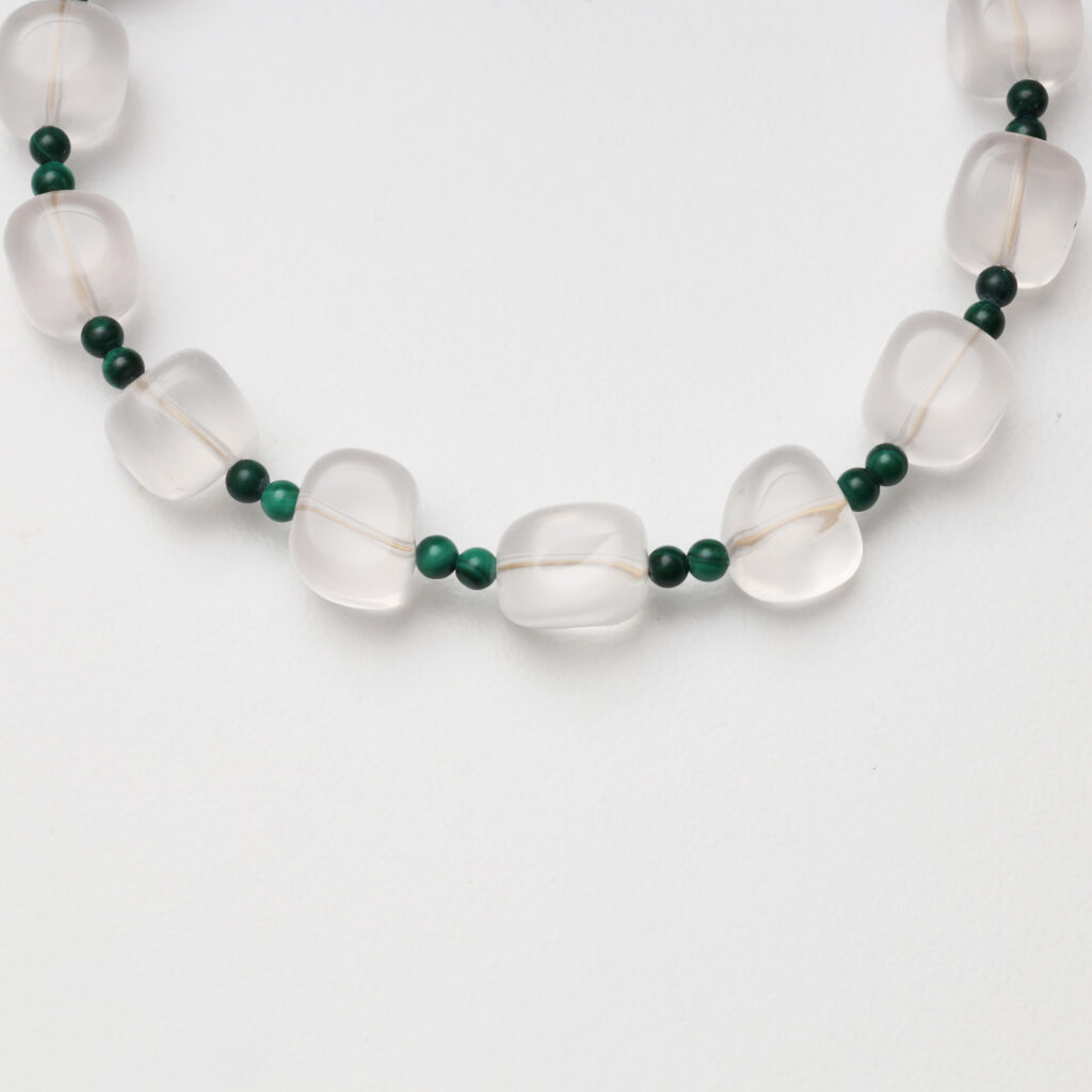 A model wearing the Moon Whisper necklace in soft light