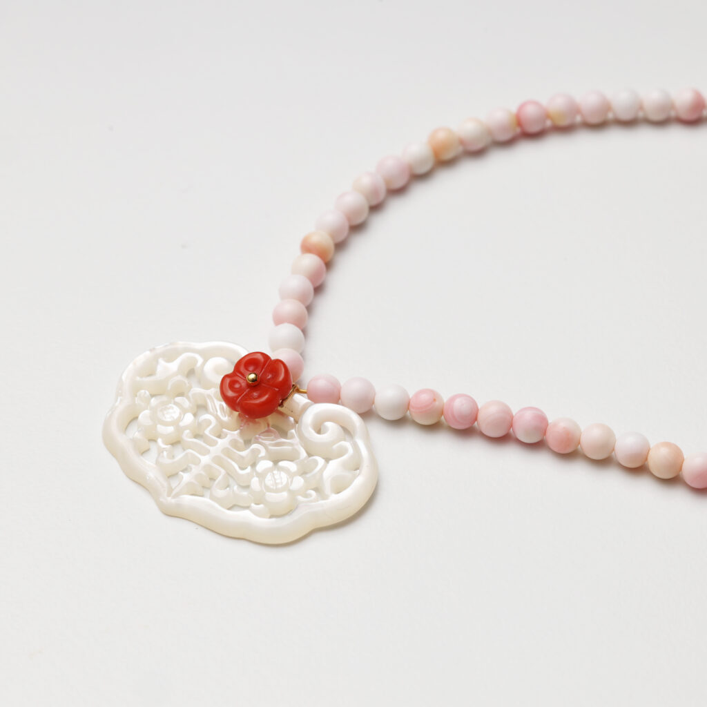 A model wearing the Moon Whisper necklace in soft light