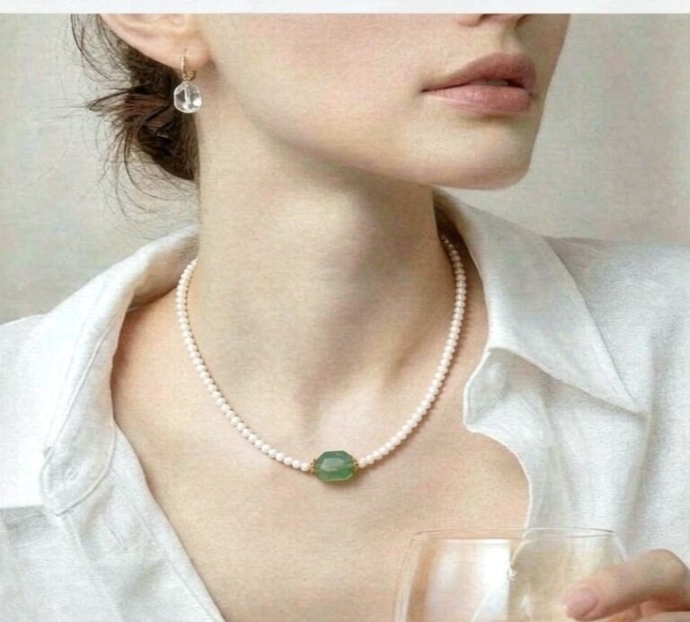 Necklace worn with an open collar